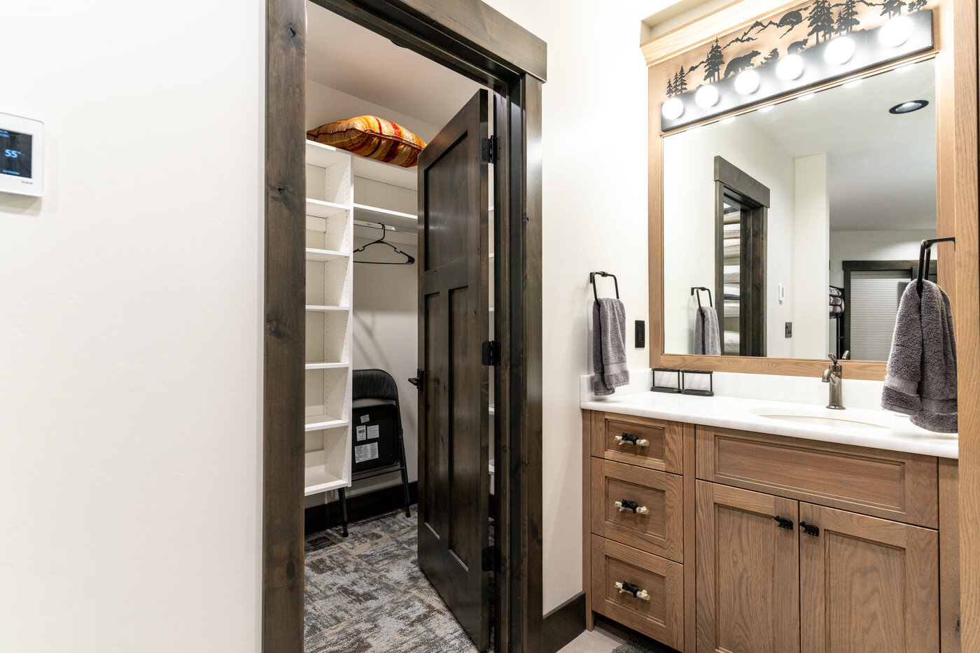 Beautiful Views — bathroom with quartz vanity and walk-in closet visible through the open door