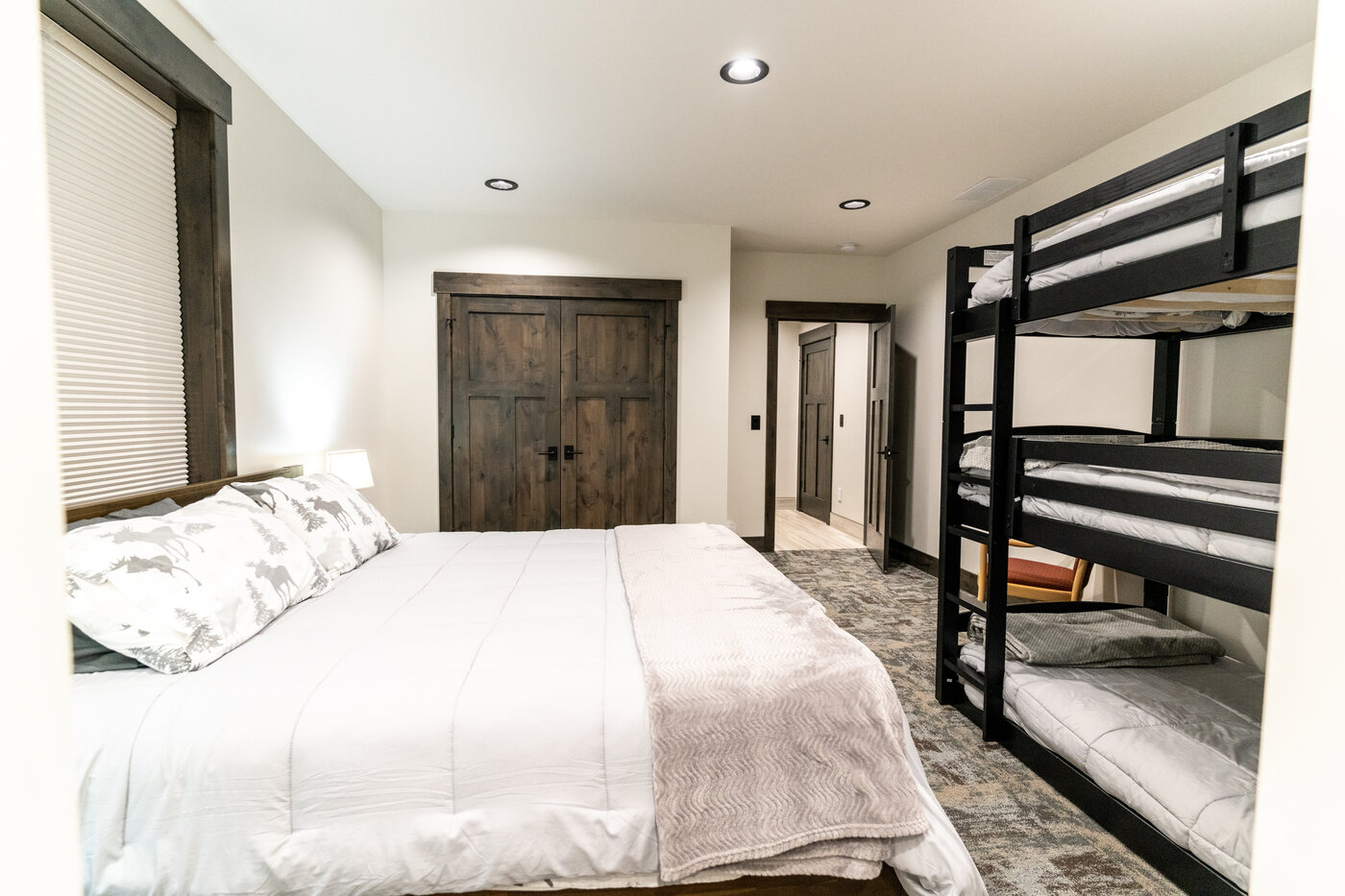 Beautiful Views — bedroom with king bed and three-tier metal bunks on the side wall
