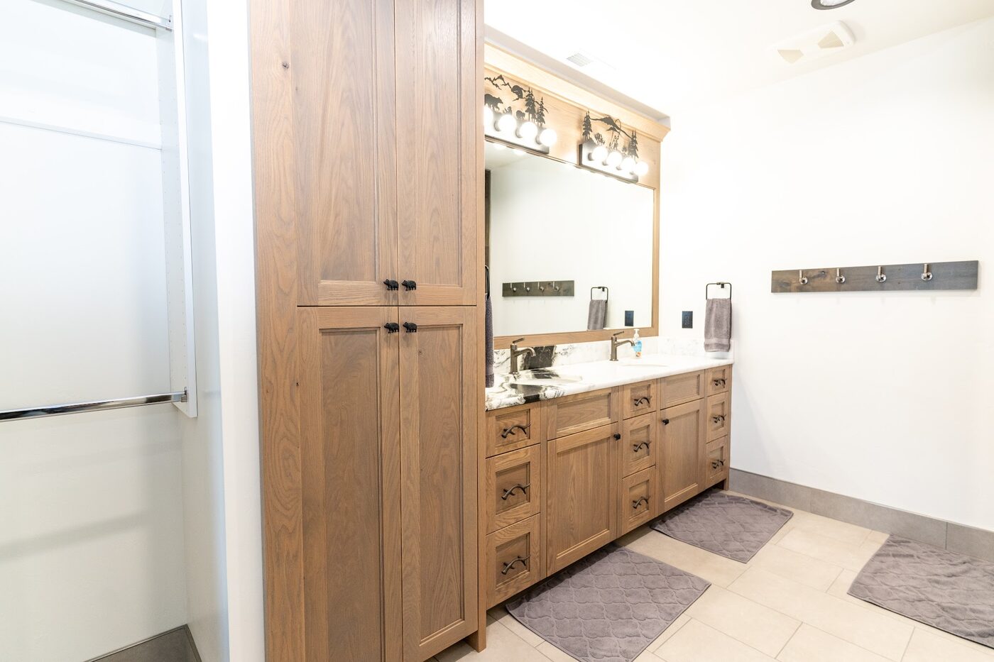 Beautiful Views — primary bathroom with double-sink granite vanity and oak cabinetry