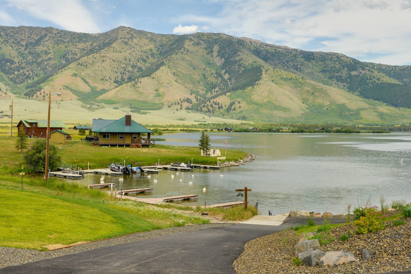 Lodge at Cutthroat Landing — view from the road with the dock, Henry's Lake, and the Centennial Range