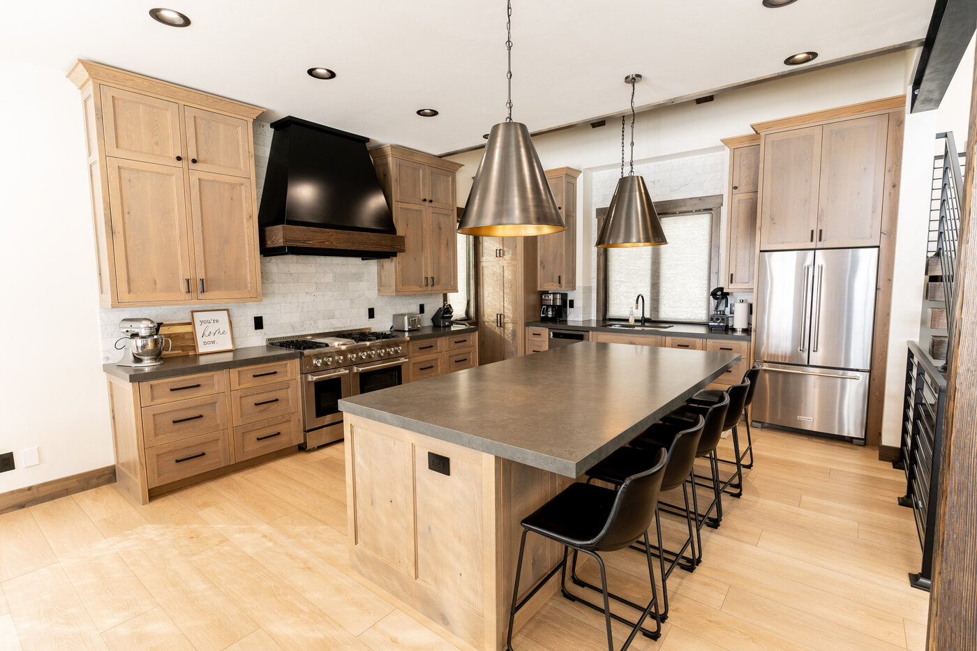 Lodge at Cutthroat Landing — kitchen detail with black range hood and stacked-stone subway-tile backsplash