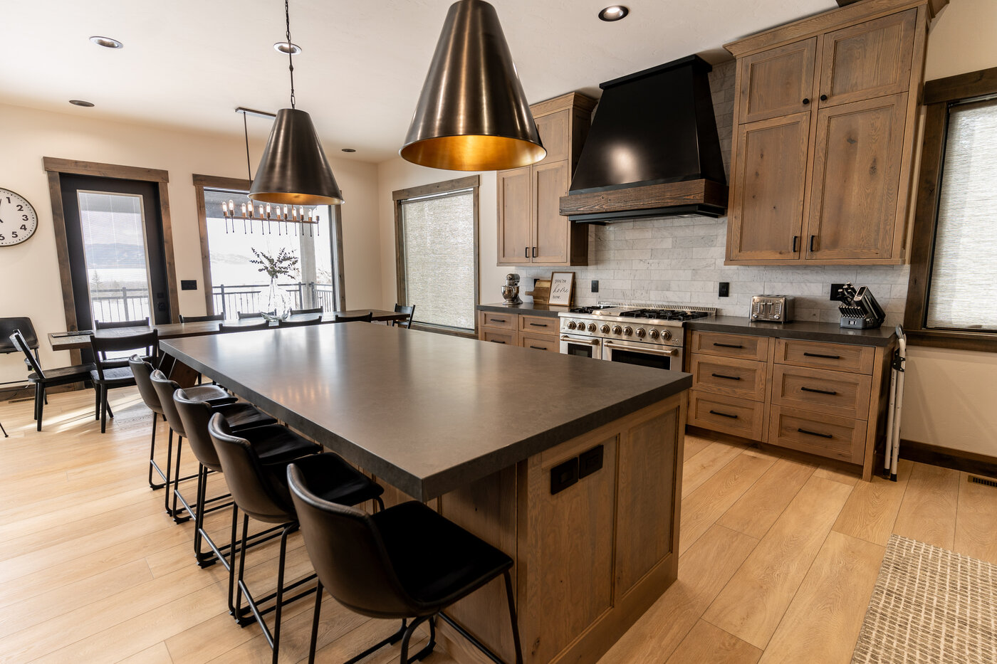 Lodge at Cutthroat Landing — kitchen prep area with brass pendants and lake view through the dining window
