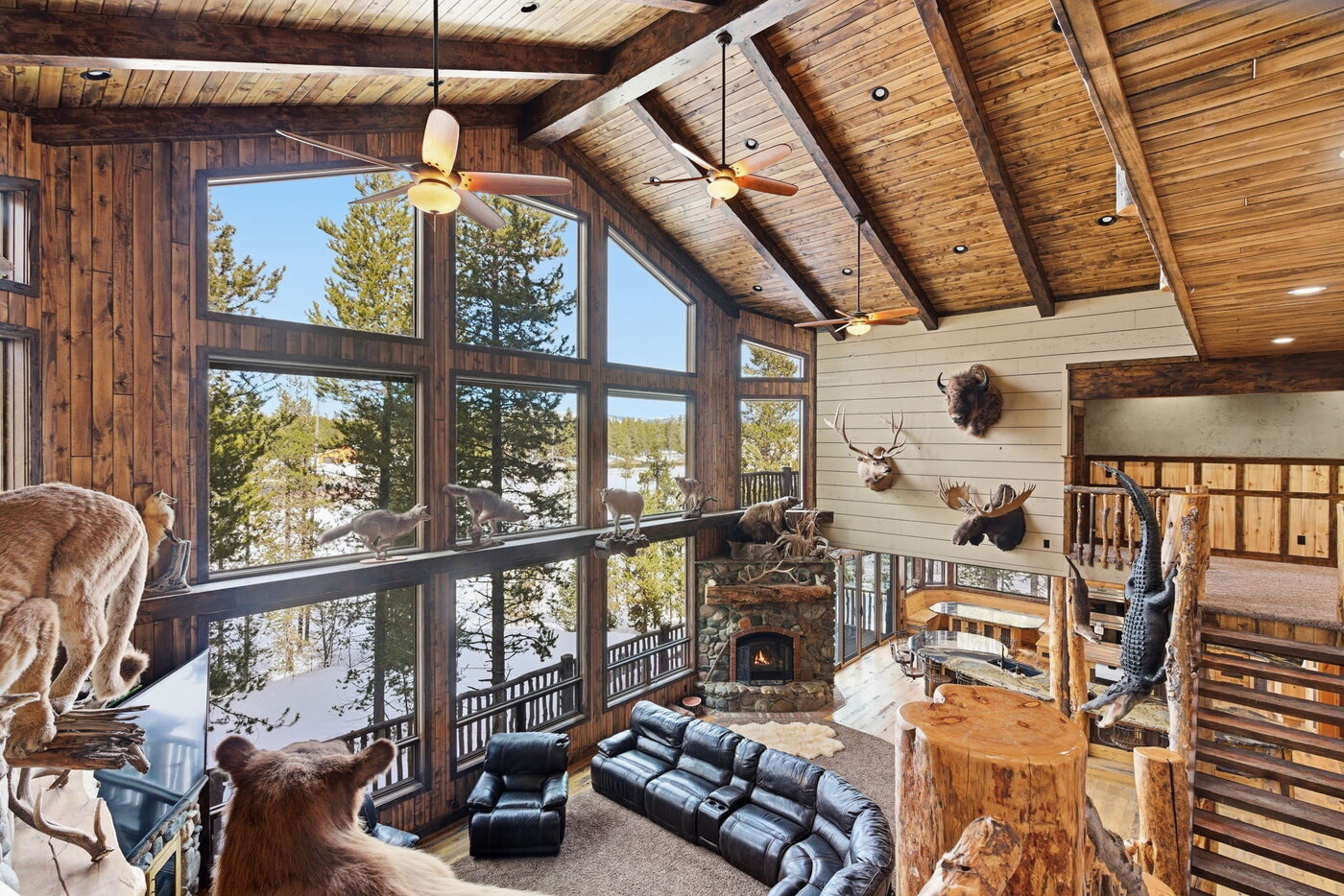 Riverfront Wildlife Lodge — great room viewed from the upper loft, taxidermy collection on far wall