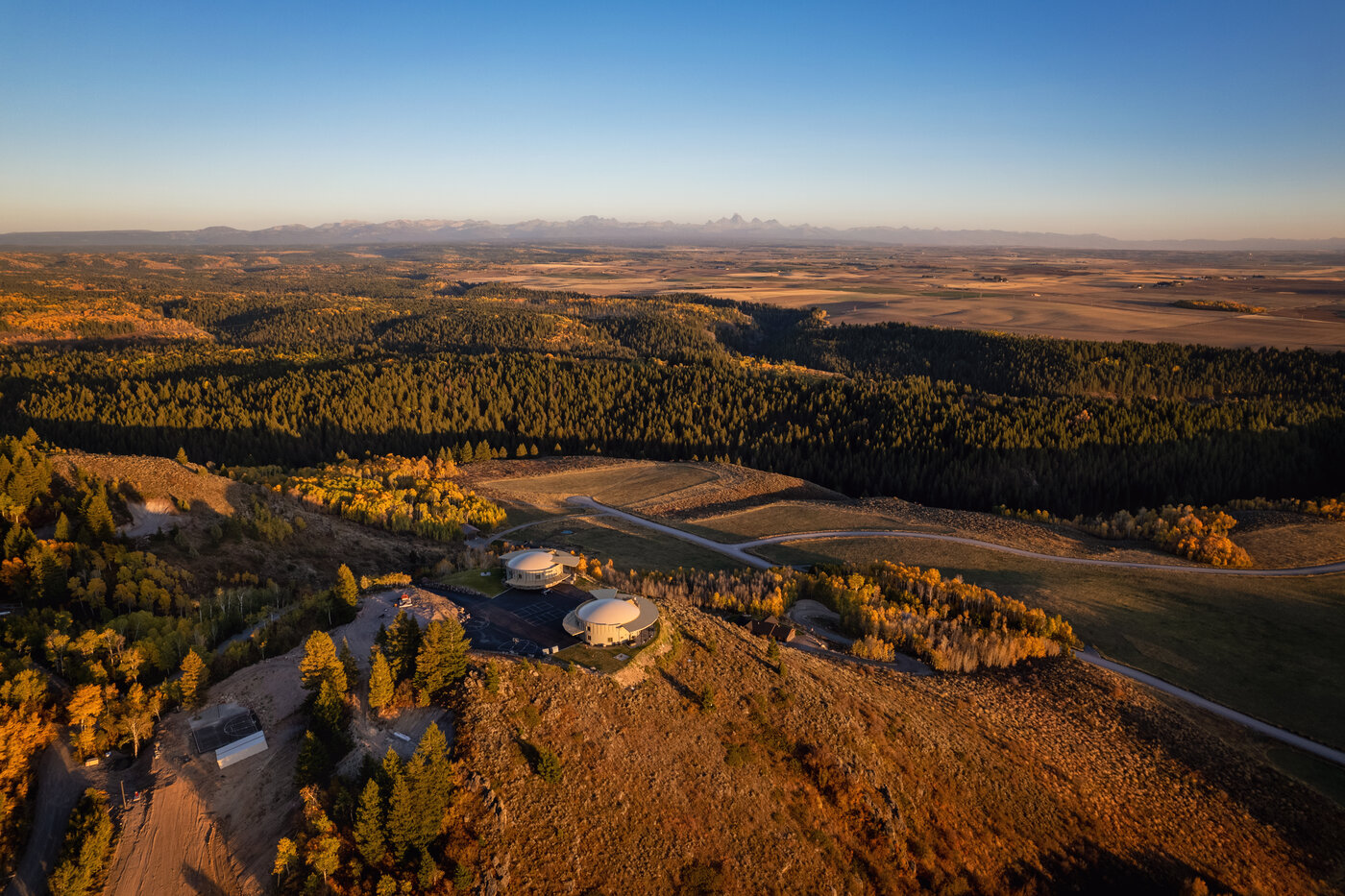 Teton View Retreat — West Cabin — twin domes with the full Teton range visible on the horizon