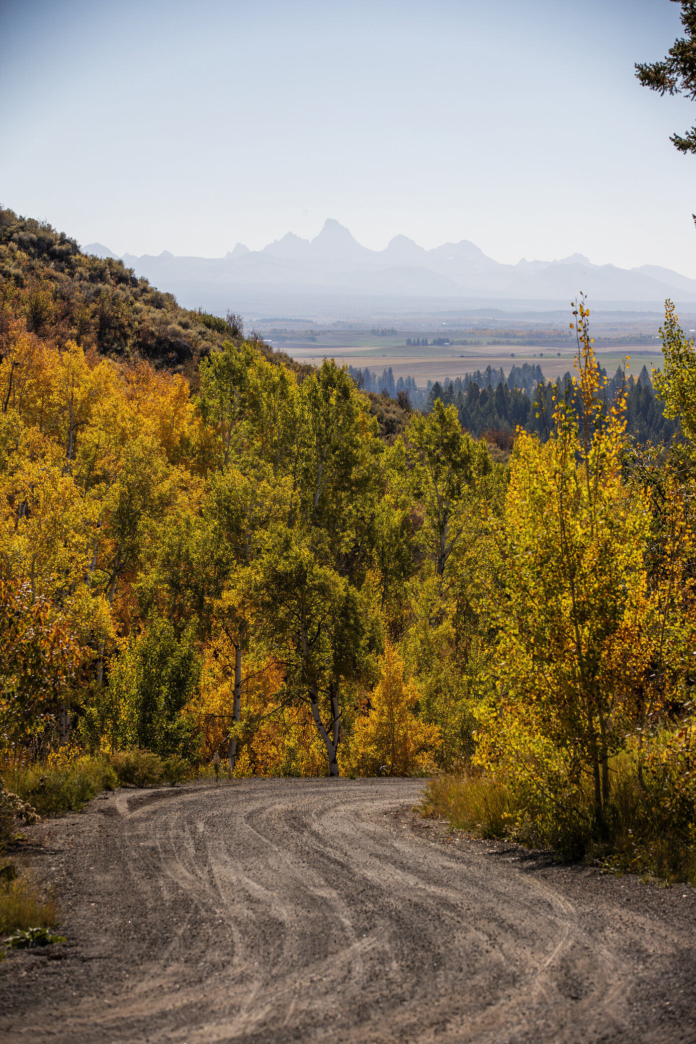 Teton View Retreat — West Cabin — dirt access road approaching the property with the Tetons in the distance