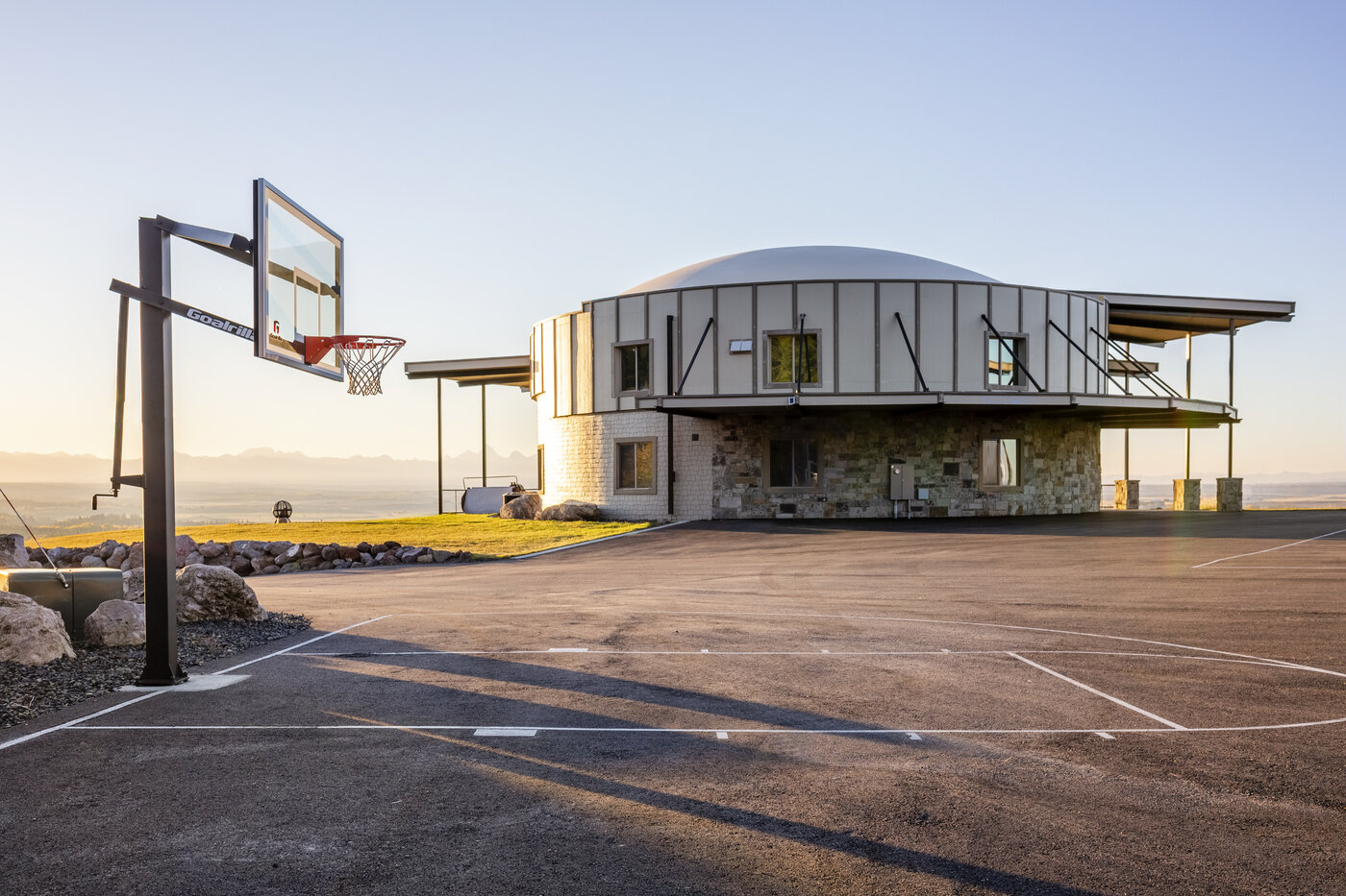 Teton View Retreat — West Cabin — dome cabin exterior with basketball court out front