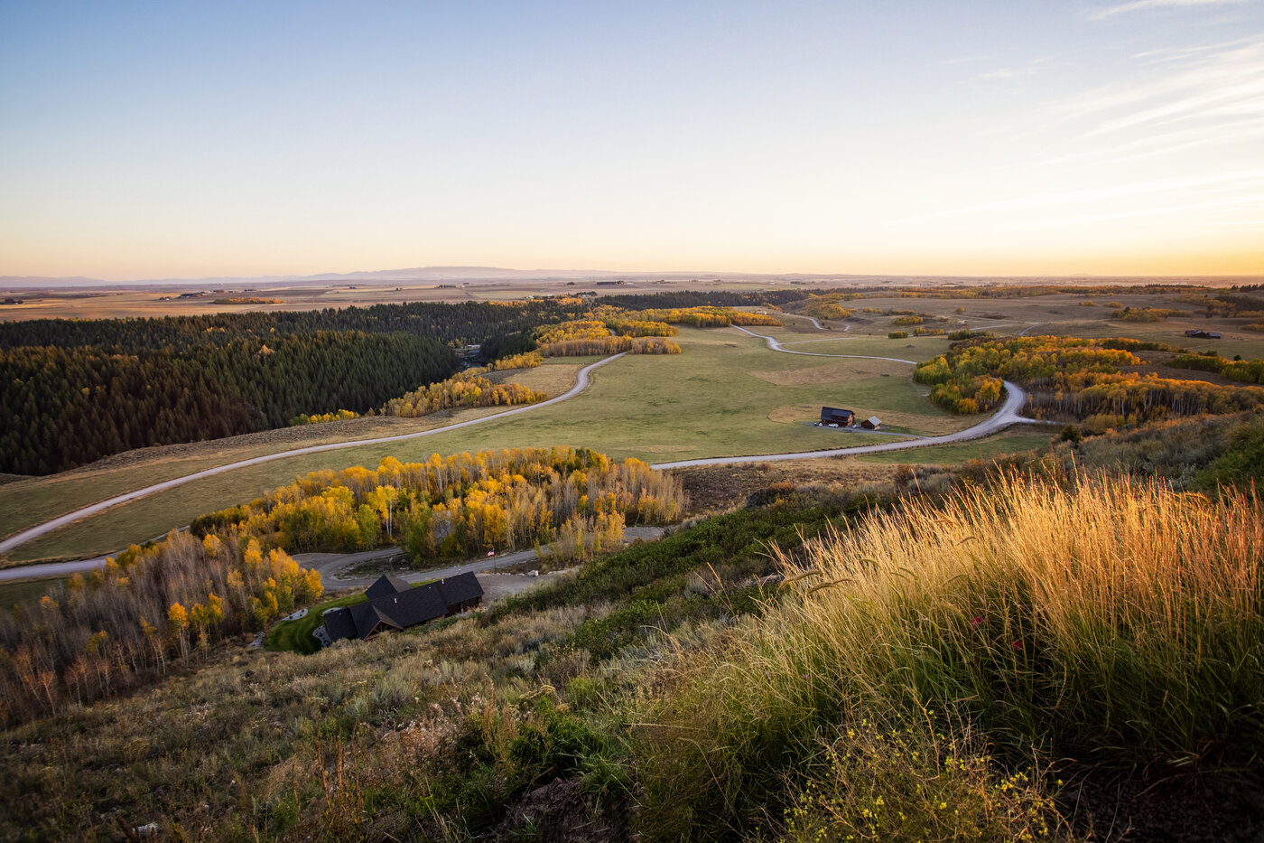 Teton View Retreat — West Cabin — sunset over the valley fields seen from the ridge