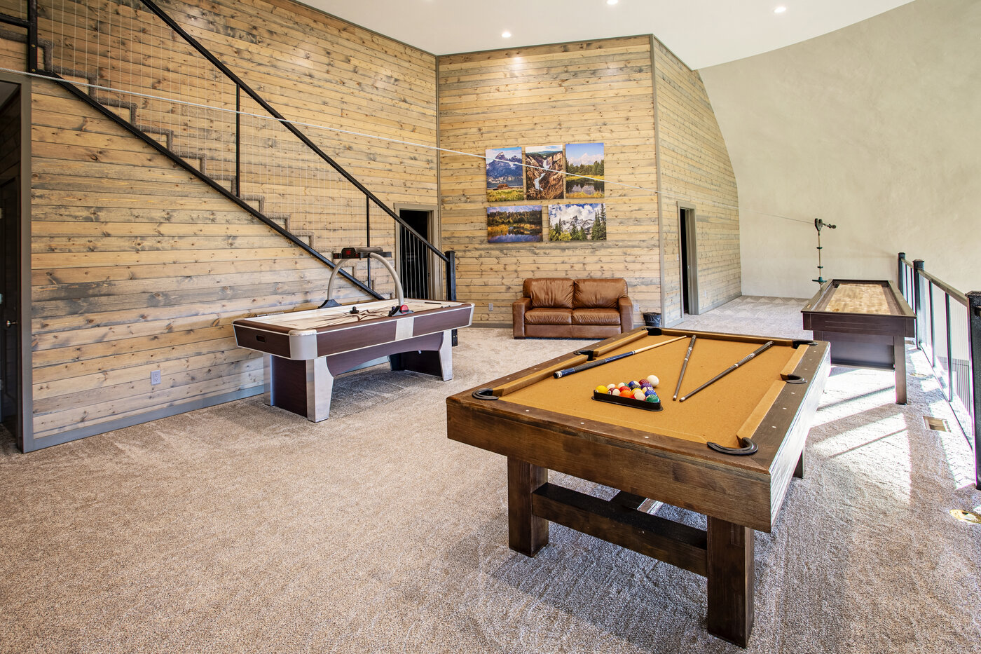 Teton View Retreat — West Cabin — upper-floor game room with pool table, air hockey, and shuffleboard