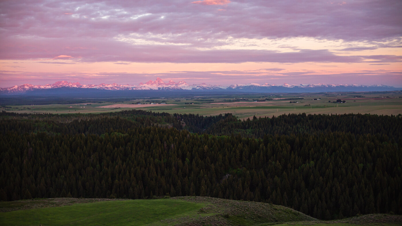 Teton View Retreat — West Cabin — panoramic Tetons at pink twilight from the property
