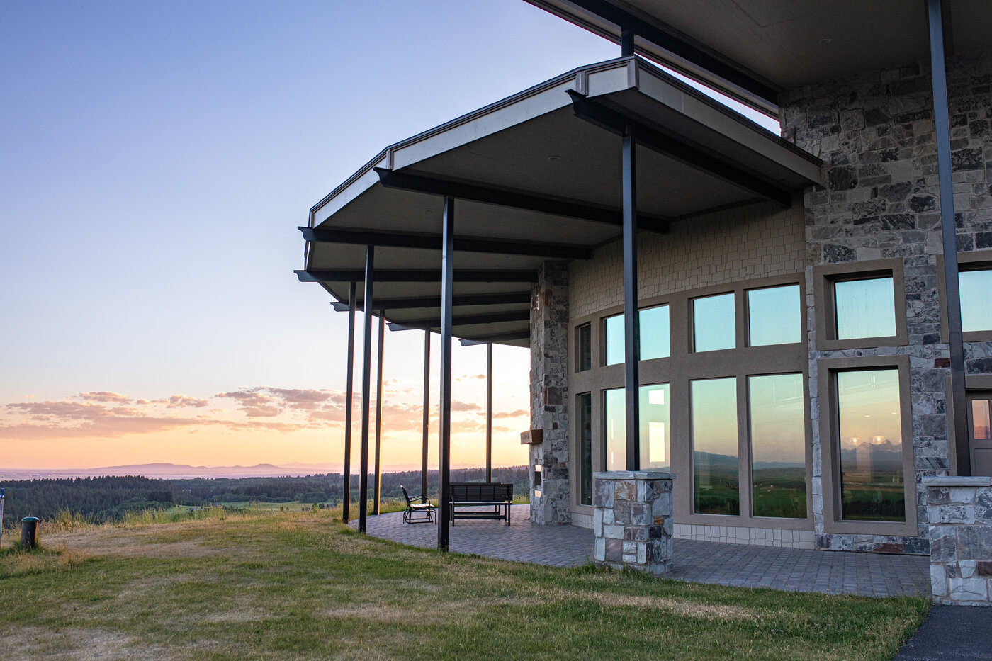 Teton View Retreat — West Cabin — cantilevered covered porch wrapping around the cabin at golden hour
