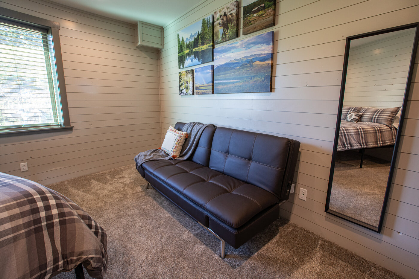 Teton View Retreat — West Cabin — bedroom with futon, queen bed, and Teton-range canvas art
