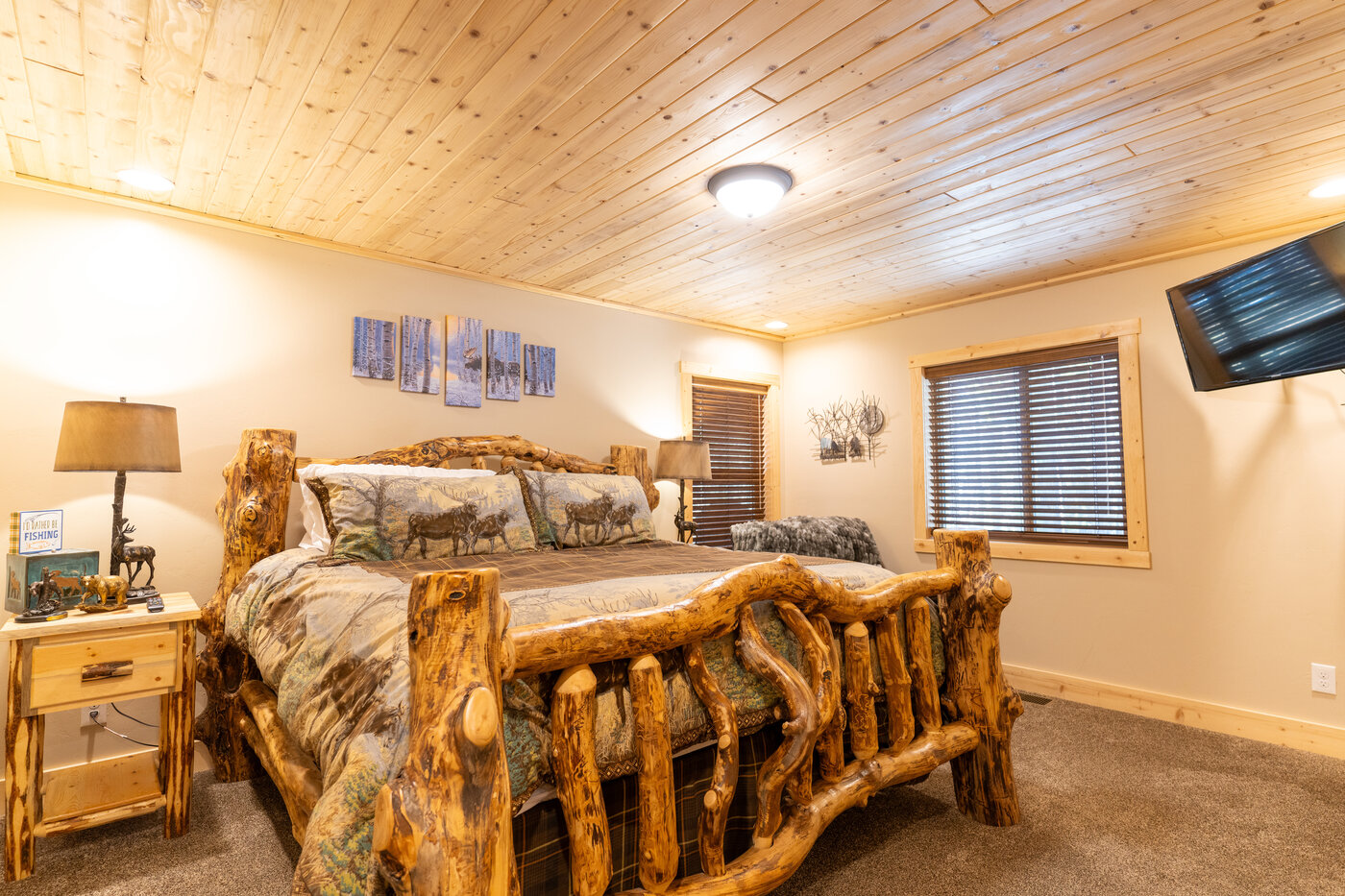 Trails End Lodge — master bedroom with aspen-log king bed and moose-print bedding