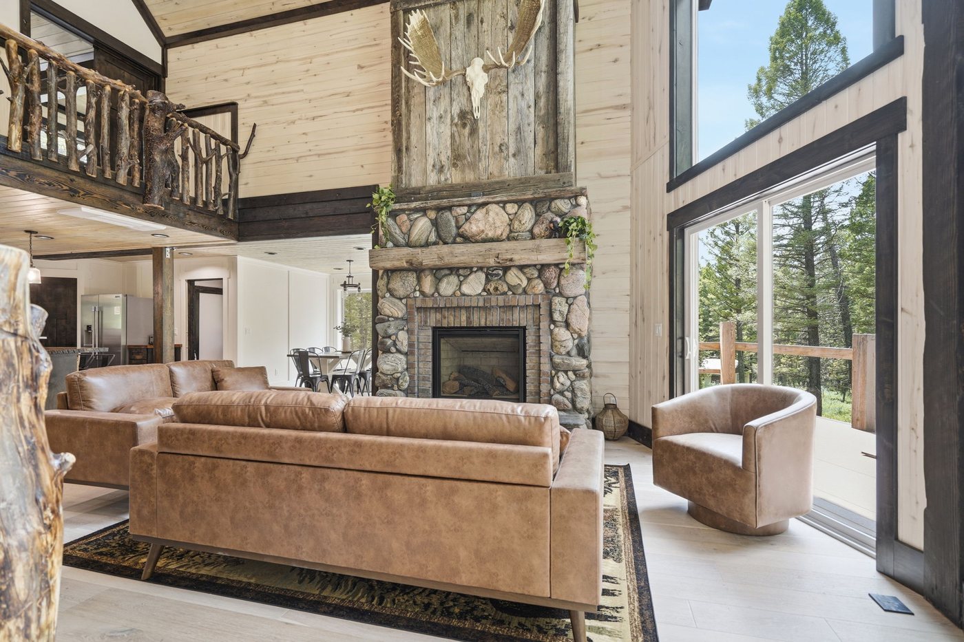 The Treehouse — two-story great room with loft above and leather seating