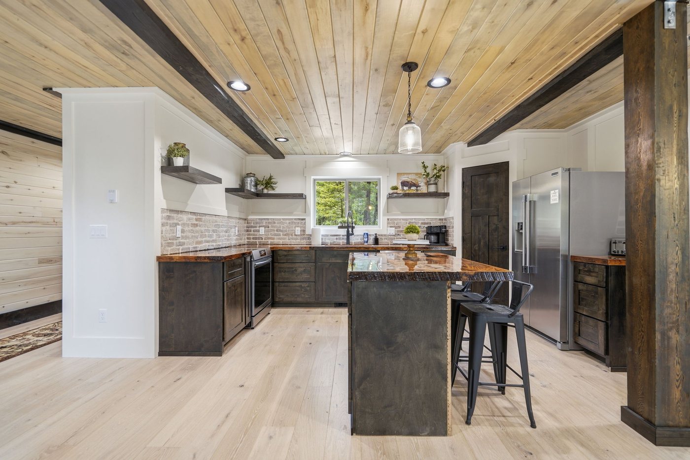 The Treehouse — open kitchen with vaulted pine ceiling
