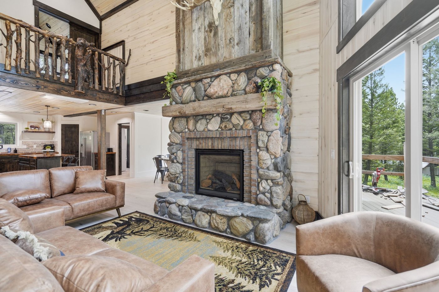 The Treehouse — living room fireplace and windows to the trees