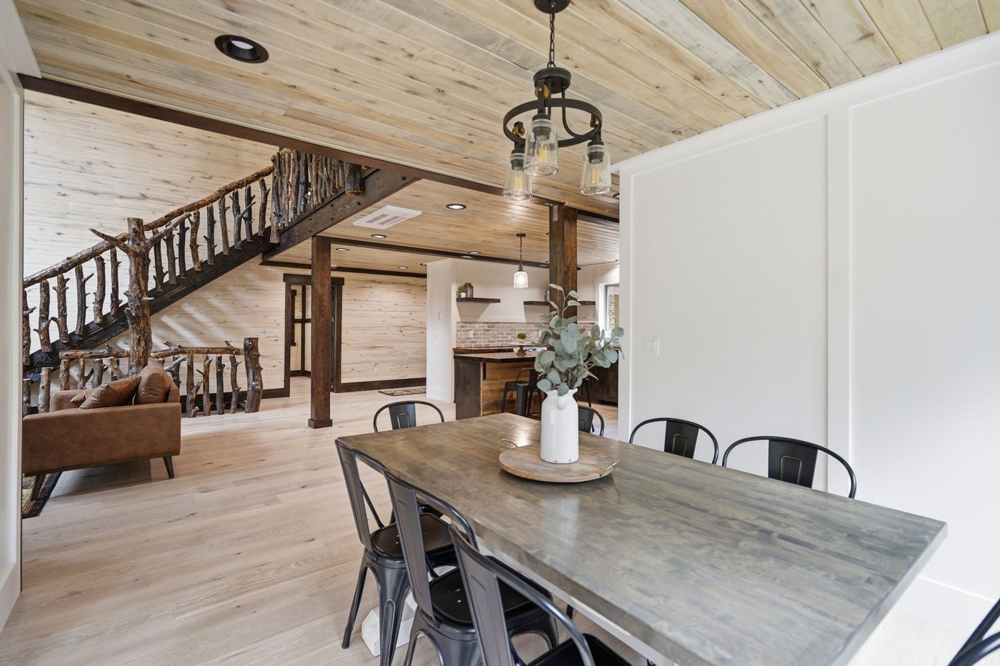 The Treehouse — dining area with metal chairs and pine ceiling