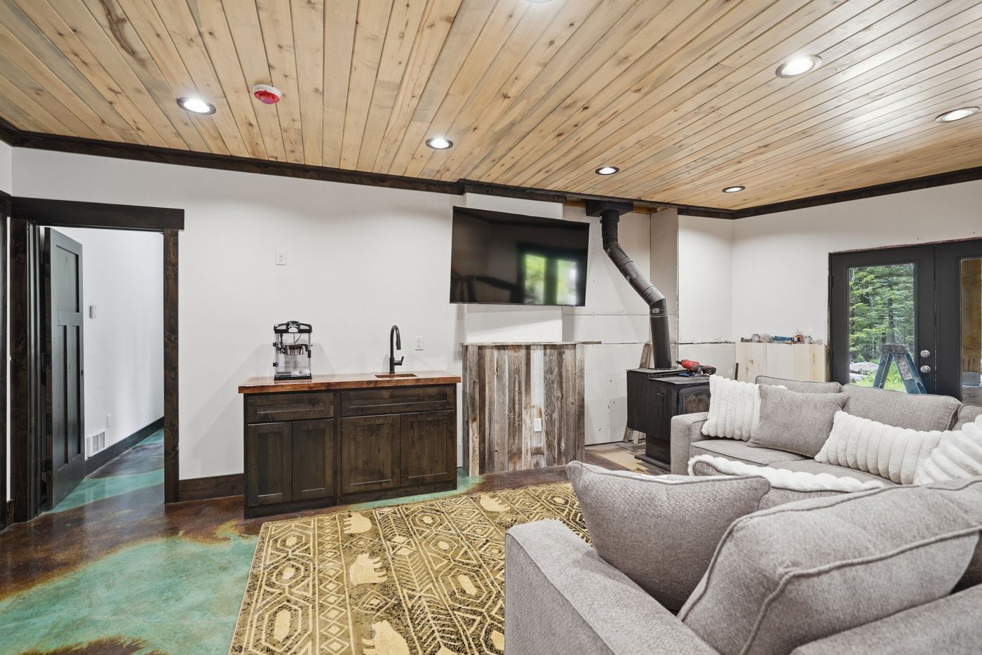 The Treehouse — family room with wood stove and seating