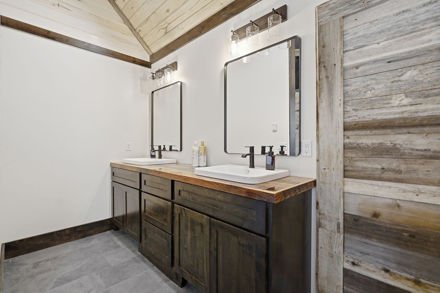 The Treehouse — double vanity bath with reclaimed wood accent wall