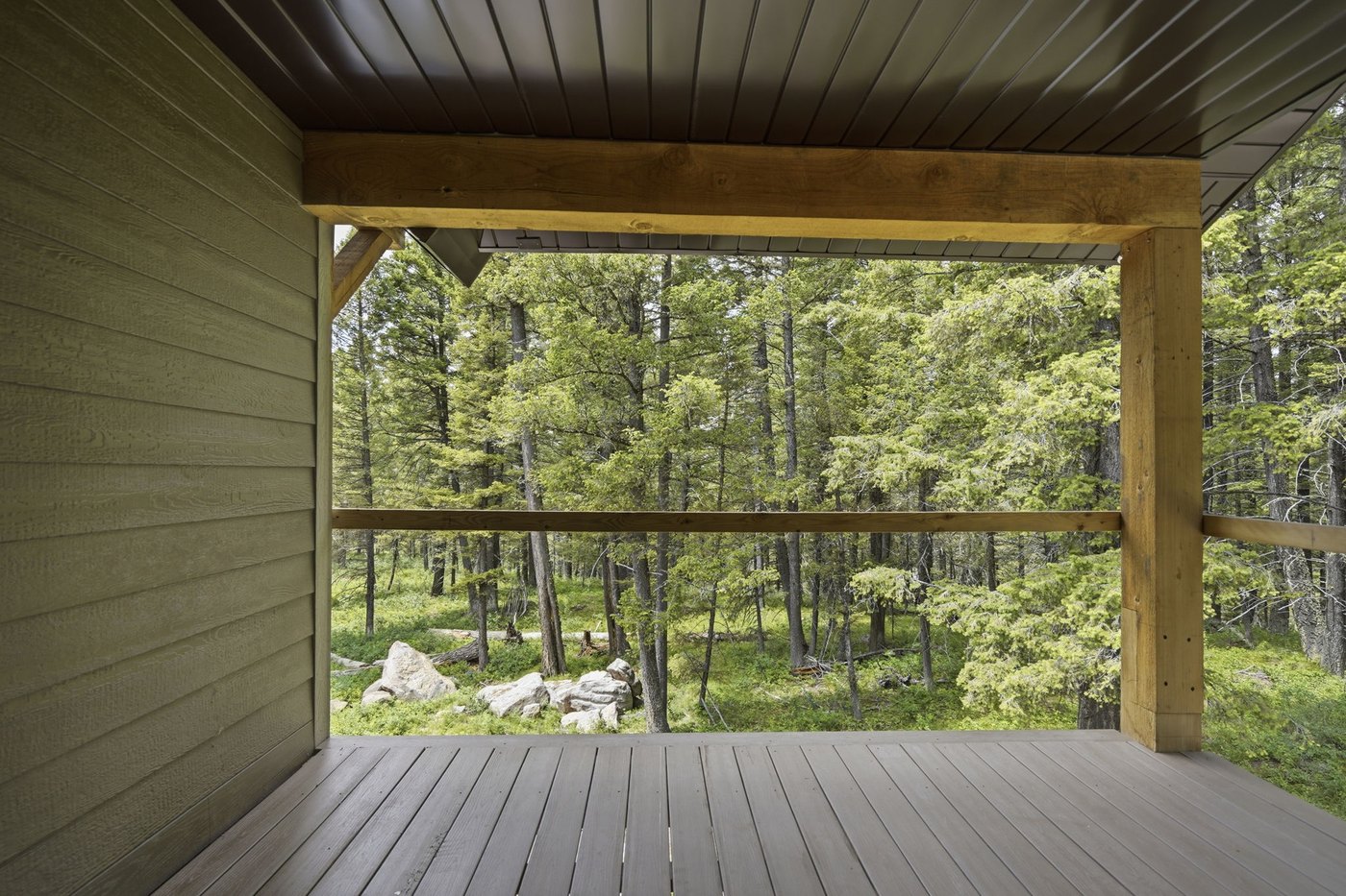 The Treehouse — covered second-floor deck in the pines
