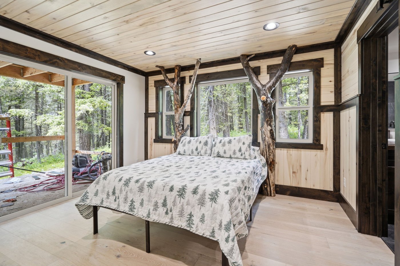 The Treehouse — bedroom with branch-built bed frame